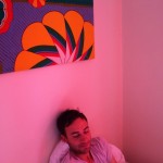 dylan in a room with red curtains